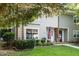 Traditional home exterior featuring a manicured lawn, brick accents, and mature landscaping at 6021 Dixon Dr, Raleigh, NC 27609