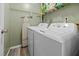Convenient laundry area with a washer and dryer with overhead shelving at 6021 Dixon Dr, Raleigh, NC 27609