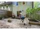 View of the patio with chairs, a grill, and a slider leading to the home's interior at 6021 Dixon Dr, Raleigh, NC 27609