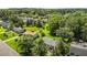 Aerial view showcases a home with spacious yard, set among mature trees, and a community of well-kept properties at 620 Red Carriage Ave, Durham, NC 27704