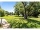 Expansive backyard with mature trees, shed, and trampoline provides ample space for outdoor activities and relaxation at 620 Red Carriage Ave, Durham, NC 27704