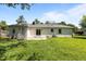 The backyard features a well-maintained lawn, a patio area, and access to the home through a sliding glass door at 620 Red Carriage Ave, Durham, NC 27704