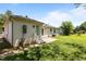 Back of home showing the brick exterior, concrete patio, and grassy area creates a private outdoor oasis at 620 Red Carriage Ave, Durham, NC 27704