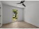 Bright bedroom with hardwood floors, ceiling fan, and a window showcasing the outdoor view at 620 Red Carriage Ave, Durham, NC 27704