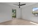 Spacious bedroom featuring wood floors, two windows, and a modern ceiling fan at 620 Red Carriage Ave, Durham, NC 27704