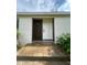 Close-up of the home's front door with white trim and adjacent accent wood at 620 Red Carriage Ave, Durham, NC 27704