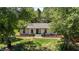 Charming home with updated landscaping and mature trees welcomes you with curb appeal and tranquility at 620 Red Carriage Ave, Durham, NC 27704