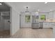 Eat-in kitchen boasts stainless appliances, shaker cabinets, and updated lighting fixtures at 620 Red Carriage Ave, Durham, NC 27704
