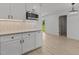 Kitchen features white shaker cabinets, modern appliances, and updated lighting fixtures at 620 Red Carriage Ave, Durham, NC 27704