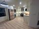 Renovated kitchen with stainless steel appliances, new countertop, and modern white cabinets at 620 Red Carriage Ave, Durham, NC 27704
