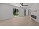 Bright living room with a modern fireplace and sliding glass door leading to the backyard at 620 Red Carriage Ave, Durham, NC 27704
