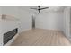 Bright living room features a modern fireplace, ceiling fan, and stylish wood-look floors at 620 Red Carriage Ave, Durham, NC 27704