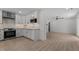 Bright living area features a modern kitchen, stylish wood-look floors, and recessed lighting at 620 Red Carriage Ave, Durham, NC 27704