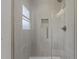 Modern shower with gray tile, a glass door, and gold hardware offers a sleek, updated bathroom experience at 620 Red Carriage Ave, Durham, NC 27704