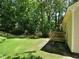 Expansive backyard with a lawn, mature trees, and a wooden deck at 637 Shadywood Ln, Raleigh, NC 27603