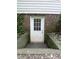 Exterior view of a basement door surrounded by brick and greenery at 637 Shadywood Ln, Raleigh, NC 27603
