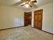 Bedroom with ceiling fan, neutral walls, and closet space at 637 Shadywood Ln, Raleigh, NC 27603