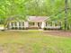 Charming single-story home with lush landscaping and a welcoming front porch at 637 Shadywood Ln, Raleigh, NC 27603