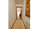 Hallway leading to rooms, featuring tan carpet and wood trim at 637 Shadywood Ln, Raleigh, NC 27603