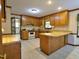 Traditional eat-in kitchen features wood cabinets, laminate countertops, and white appliances at 637 Shadywood Ln, Raleigh, NC 27603