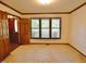 Spacious living room with wood trim, carpet flooring, and natural light at 637 Shadywood Ln, Raleigh, NC 27603