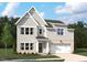 Charming two-story home with gray siding, brick accents, manicured lawn and attached two-car garage at 713 Compeer Way # 33, Wake Forest, NC 27587