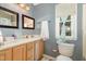 Cozy bathroom features a double sink vanity, framed mirrors, and natural light from the window at 713 Saint Catherines Dr, Wake Forest, NC 27587