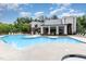 Inviting community pool area surrounded by lounge chairs, tables and umbrellas, perfect for summertime relaxation at 7250 Nc 751 Highway, #1205, Durham, NC 27707