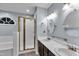 En-suite bathroom features dual sinks, walk-in shower, and soaking tub at 8 Great Oak Ct, Durham, NC 27713