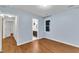 Bedroom with wood-look floors and a view into the ensuite bathroom at 8 Great Oak Ct, Durham, NC 27713