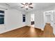 Large bedroom with vinyl floors, a ceiling fan, and windows overlooking the yard at 8 Great Oak Ct, Durham, NC 27713