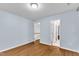 Bedroom with wood-look floors, a doorway to the bathroom and a view of the stairs at 8 Great Oak Ct, Durham, NC 27713