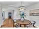 Charming dining room with hardwood floors, modern chandelier, and easy access to other rooms at 8 Great Oak Ct, Durham, NC 27713