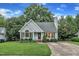 Charming single-story home with tidy landscaping, blue siding, and a well manicured lawn at 8 Great Oak Ct, Durham, NC 27713