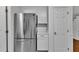 Stainless steel refrigerator adjacent to white cabinets and quartz countertops at 8 Great Oak Ct, Durham, NC 27713