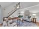 Inviting living room with hardwood floors, staircase, modern decor, and plenty of natural light at 8 Great Oak Ct, Durham, NC 27713
