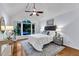 Vaulted main bedroom features a ceiling fan, large window, and hardwood flooring at 8 Great Oak Ct, Durham, NC 27713