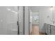 Modern bathroom with white subway tile in the shower and a white vanity with a gold faucet at 807 Outlaw Ave # 19, Durham, NC 27703