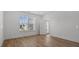 Sunlit bedroom with wood floors, featuring bright windows, and back door access to the exterior at 807 Outlaw Ave # 19, Durham, NC 27703