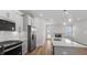This stylish kitchen features stainless steel appliances and a large island with a sink and white countertops at 807 Outlaw Ave # 19, Durham, NC 27703