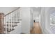 Staircase leading upstairs to the home's bedrooms and with natural light from the bright front window at 807 Outlaw Ave # 19, Durham, NC 27703