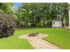 Serene backyard with a fire pit, lush greenery, and storage shed at 8116 Mosby Way, Willow Springs, NC 27592