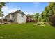Beautifully landscaped backyard with a deck, expansive lawn, and mature trees at 8116 Mosby Way, Willow Springs, NC 27592