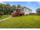 Expansive backyard with a deck, lush greenery, and a charming stone pathway at 8116 Mosby Way, Willow Springs, NC 27592