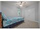 Neutral-toned bedroom featuring a window with natural light and a double door closet at 8116 Mosby Way, Willow Springs, NC 27592