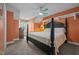 Bright bedroom with neutral carpet, orange walls, and black-framed furniture at 8116 Mosby Way, Willow Springs, NC 27592