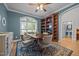 Dining room features a table with seating, hardwood floors, and a window with natural light at 8116 Mosby Way, Willow Springs, NC 27592