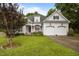 Charming two-story home with a well-manicured lawn, flowering plants, and a two car garage at 8116 Mosby Way, Willow Springs, NC 27592