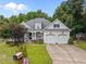 Charming two-story traditional home with manicured landscaping, two-car garage, and welcoming curb appeal at 8116 Mosby Way, Willow Springs, NC 27592