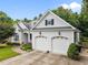 Charming home featuring a two-car garage, well-manicured lawn, and inviting curb appeal at 8116 Mosby Way, Willow Springs, NC 27592
